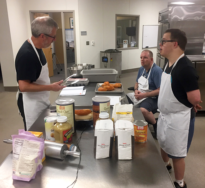 Bryan Severns helps formulate pumpkin-based pet treats with PawsAbilities staff.