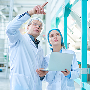 Two bioscience professionals supervising a scientific lab.