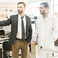 Two regulatory affairs workers in the lab.