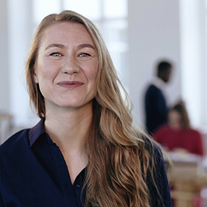 Woman smiling because she was offered a new job because of her newly learned skills.