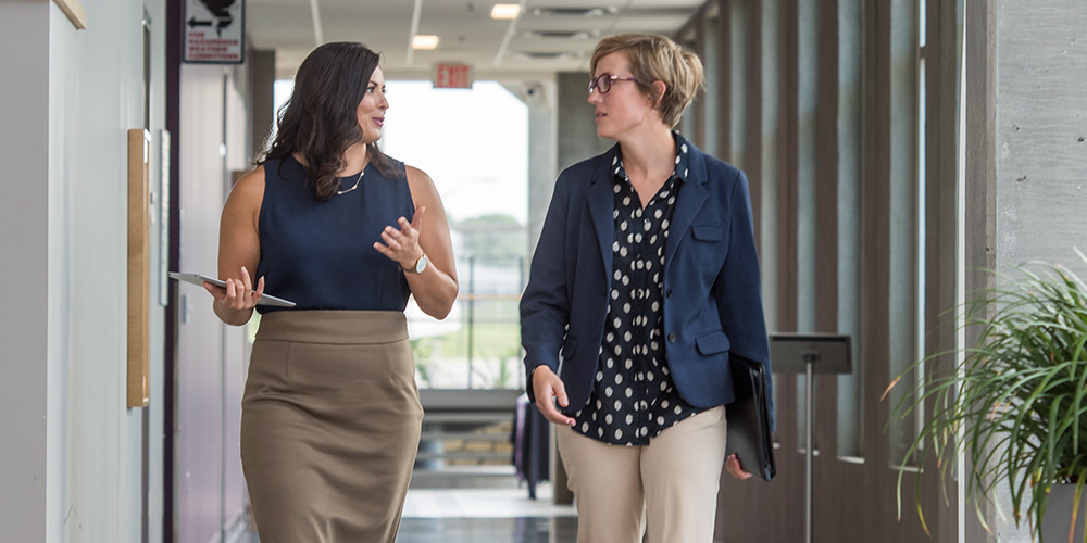 Two women talking on the K-State Olathe campus.