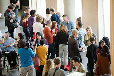 Conference attendees visiting at an event. 