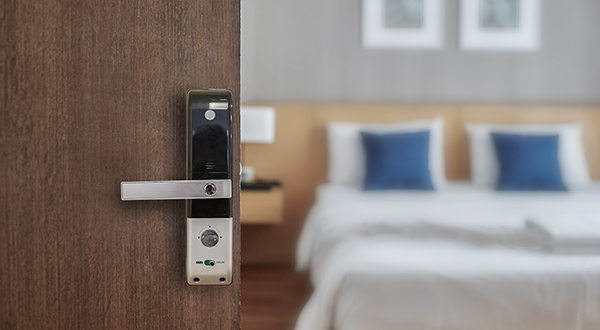 Hotel door opening up to hotel room.