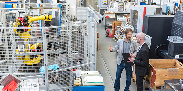 Foreman and worker discussing operational data about the production line.