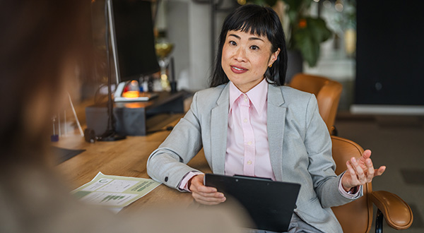 Woman confidently presenting an idea to her team.