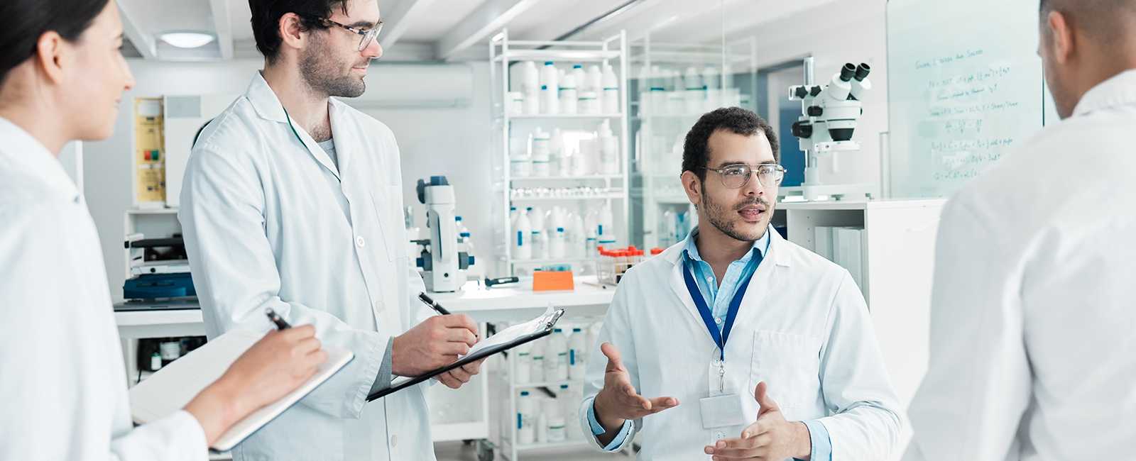 Scientists talking to each other in the lab.