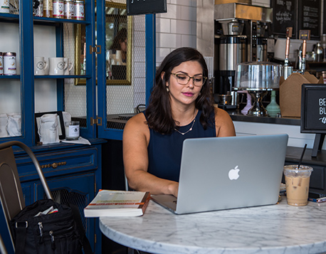 Attractive woman using laptop in coffee shop. 