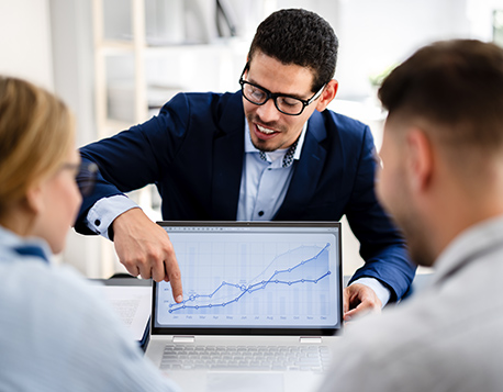 Wealth advisor talking to clients about their portfolio projections.