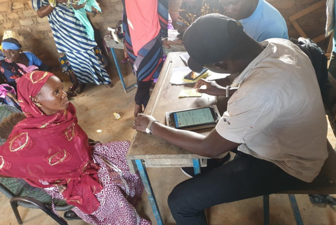 A local NGO agent verifying the credentials of a participant In Boidie village, Baroueli Circle, Segou region.