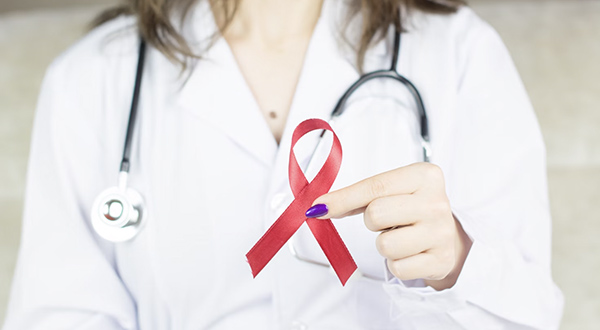 Hands holding a ribbon that signifies stomach cancer.